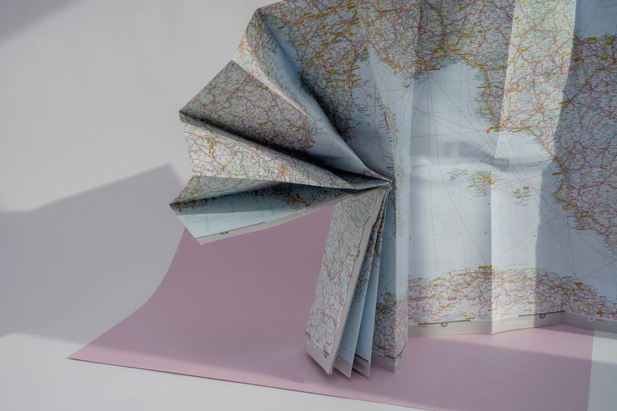 Folded paper road map arranged for planning a slow weekend trip.