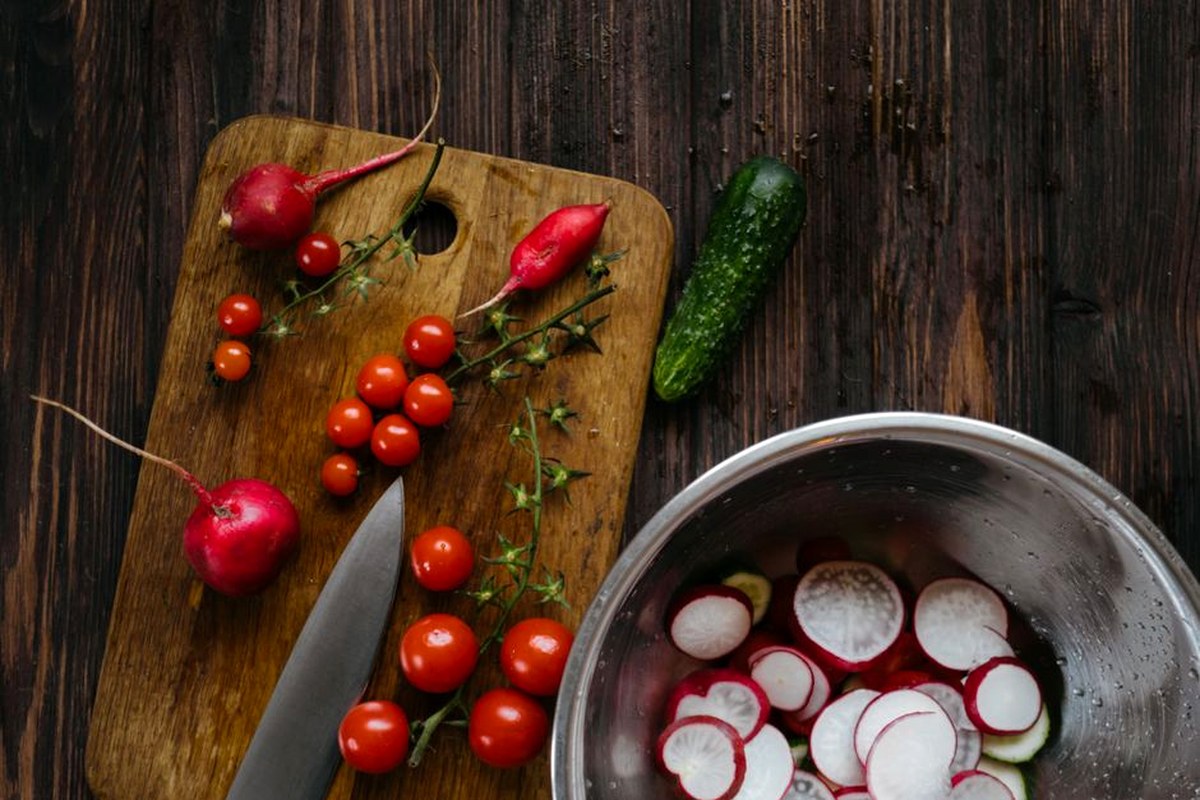 Fresh radishes, tomatoes, cucumber, and herbs ready for a simple summer lunch.